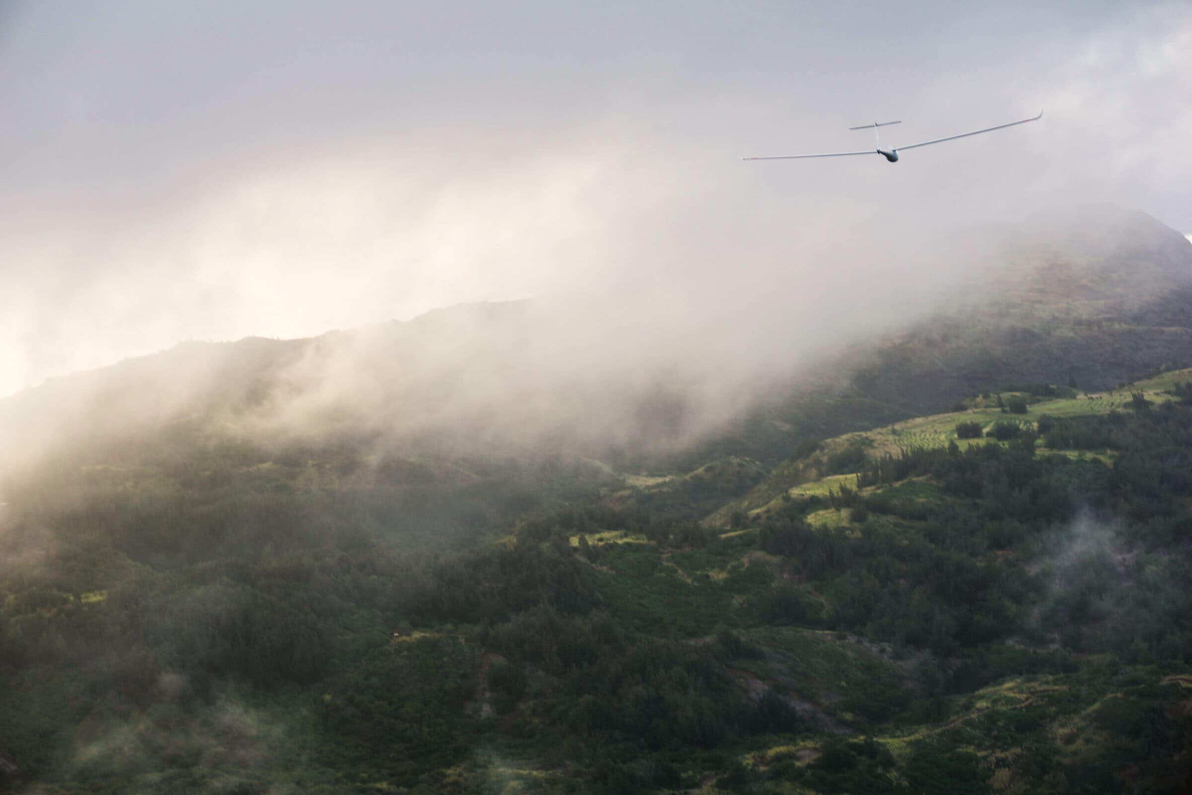 Mist drifting across the deep green folds of the Wai‘anae mountains seen from the air